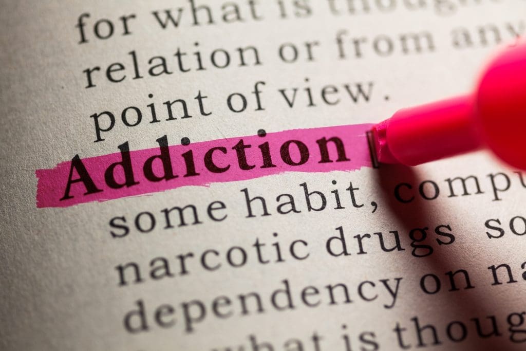 Addiction dictionary definition highlighted in pink