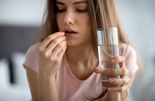 Woman taking pill
