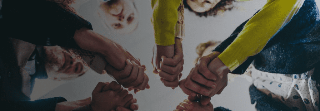 Group together holding hands shot from underneath