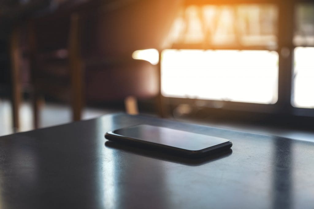 smart phone on a table with sunlight coming in